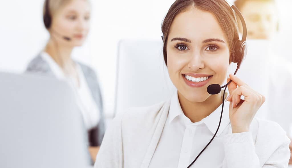 Woman in headset communicating with customers of call center